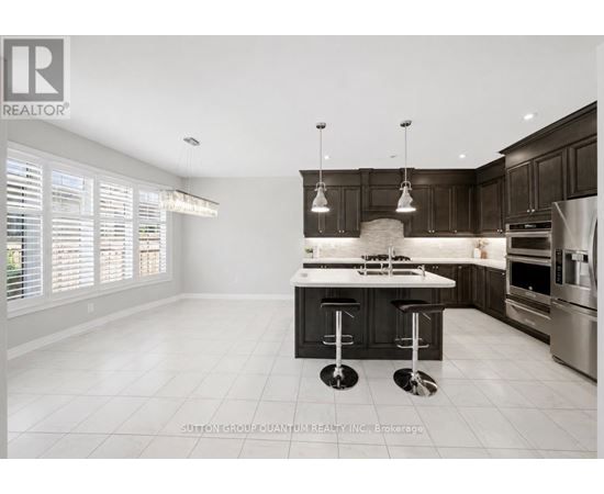 A modern kitchen with a bar stool in the middle.
