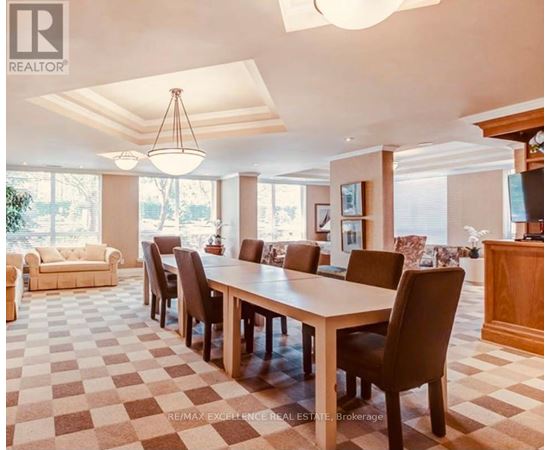 A large dining room with a checkered floor and a long table with chairs.