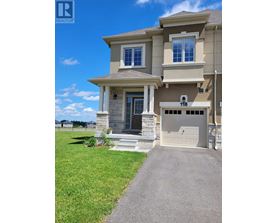 A two-story house with a garage and a driveway.