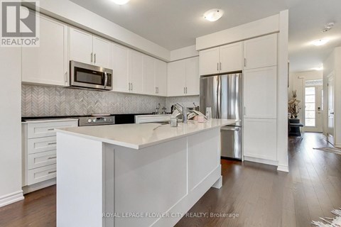 A kitchen with white cabinets and a counter top.