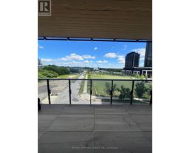 A balcony with a view of a road and buildings.