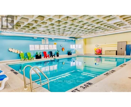 A swimming pool in a room with a blue wall.