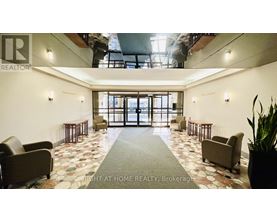 A large open space with a tiled floor and a glass door leading to a balcony.