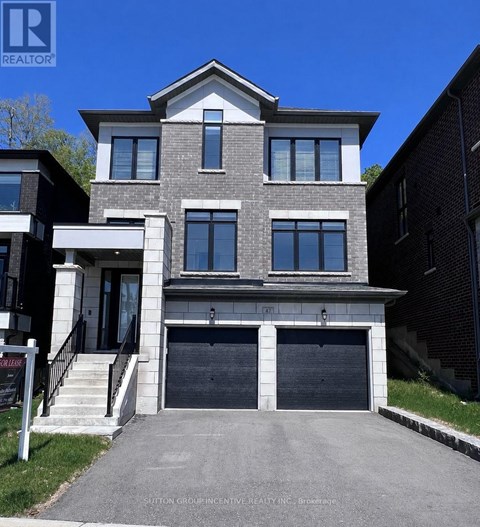 A modern two-story house with a garage is for sale.