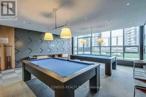 A pool table in a room with a view of the city.