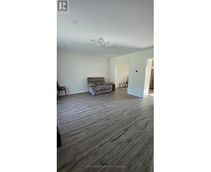 A living room with a couch and a chair.