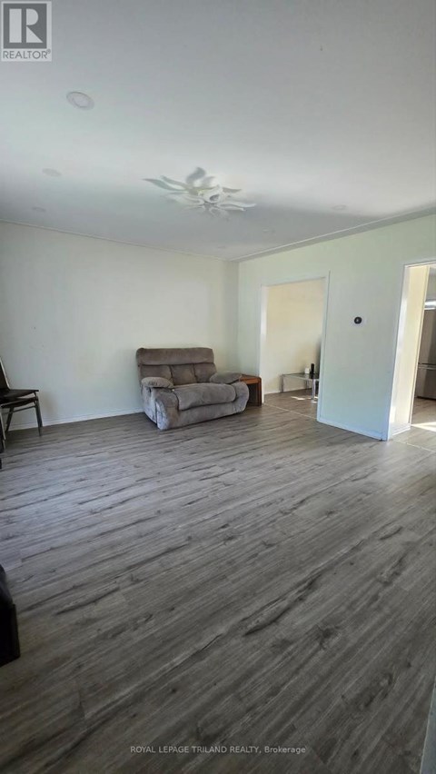A living room with a couch and a chair.