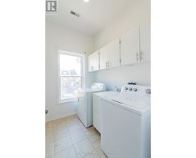 A white washer and dryer in a small laundry room.