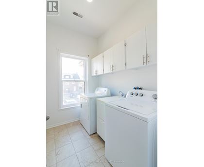 A white washer and dryer in a small laundry room.