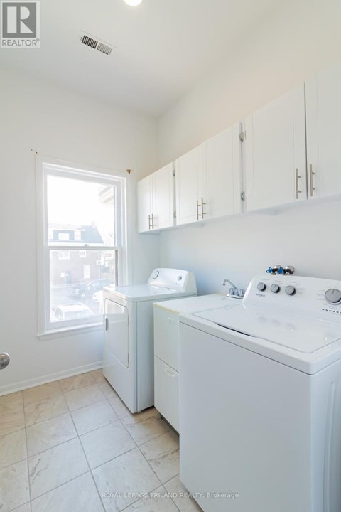 A white washer and dryer in a small laundry room.