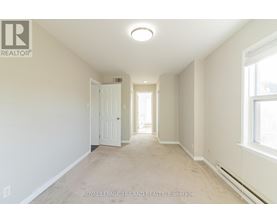 A white room with a door and a window.