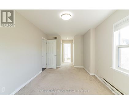 A white room with a door and a window.