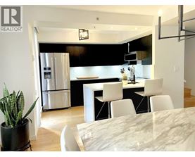 A modern kitchen with a dining table and chairs.