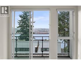 A view of a cityscape through a window with a Realtor sign.