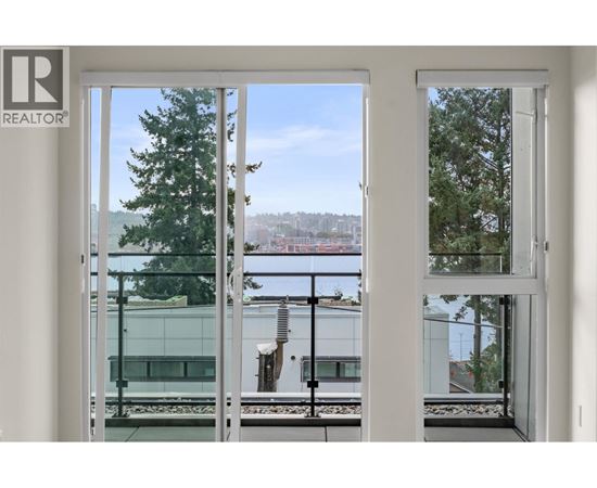 A view of a cityscape through a window with a Realtor sign.