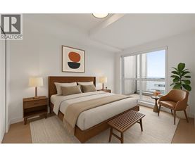 A bedroom with a large bed, a chair, and a plant.
