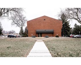 A building with a brick facade and a sign that says "Chatham-Kent Association of REALTORS".