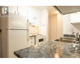 A kitchen with a granite countertop and white appliances.