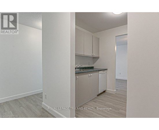 A kitchen with white cabinets and a countertop.