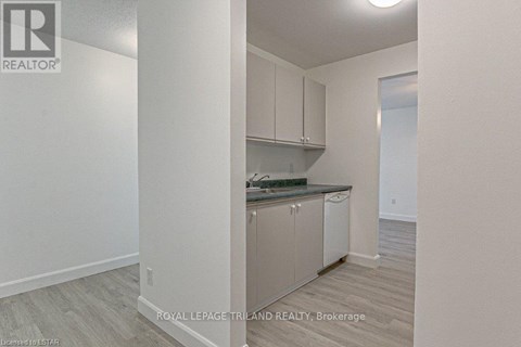 A kitchen with white cabinets and a countertop.