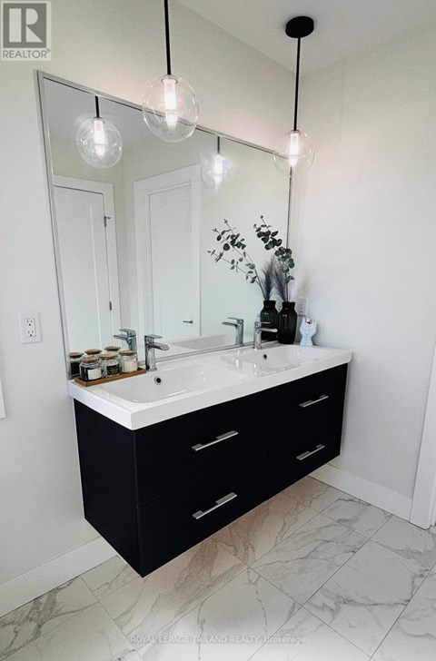 A bathroom with a sink and a mirror.
