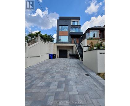 A modern house with a driveway in front.
