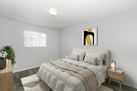 A bedroom with a large bed and a painting on the wall.