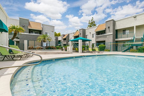 A swimming pool in front of apartment buildings.