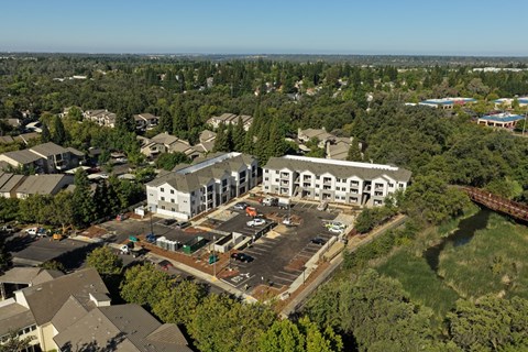 A large white building with a parking lot in front of it.