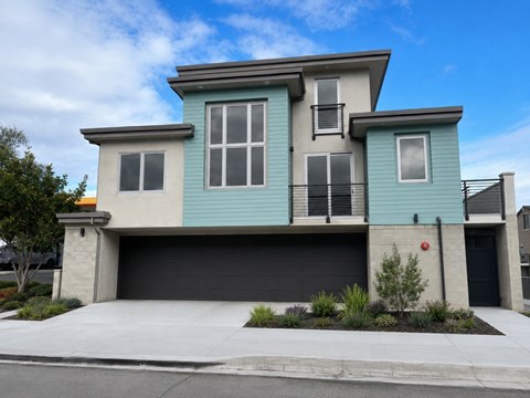 A modern two-story house with a garage.
