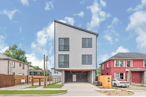 A modern two-story house with a garage is situated in a residential area.