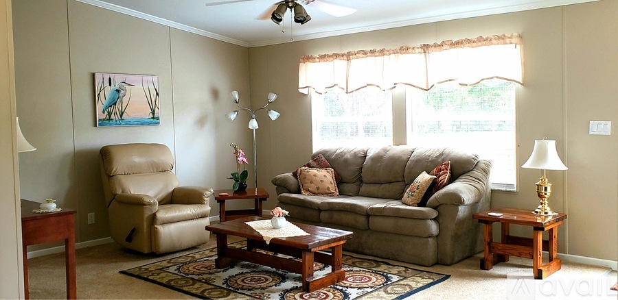 A living room with a couch, chair, and table.