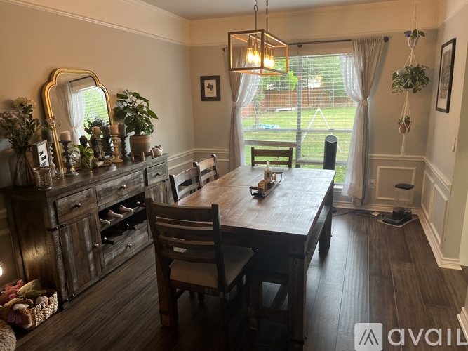 A dining room with a wooden table and chairs.
