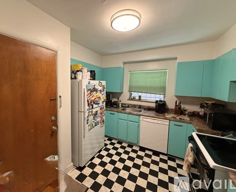 A kitchen with a black and white checkered floor.