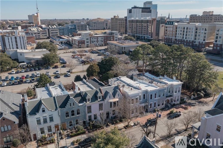 A bird's eye view of a city street with buildings and cars.