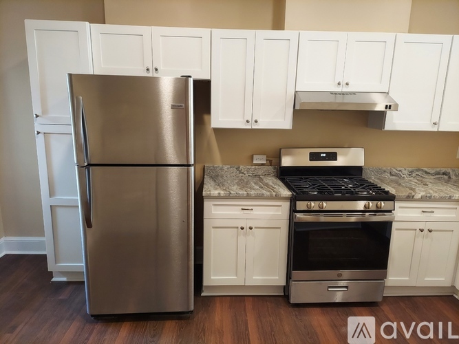 A kitchen with a stainless steel refrigerator and stove.