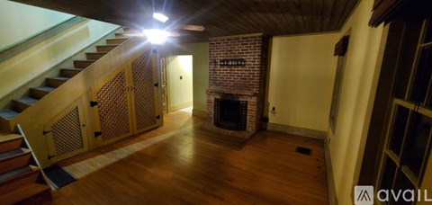A wooden staircase with a light on the side.