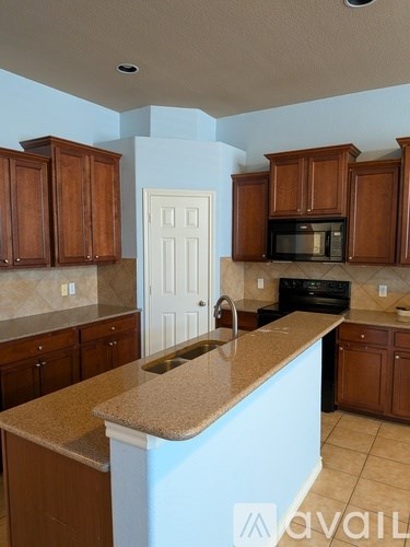 A kitchen with brown cabinets and a countertop.