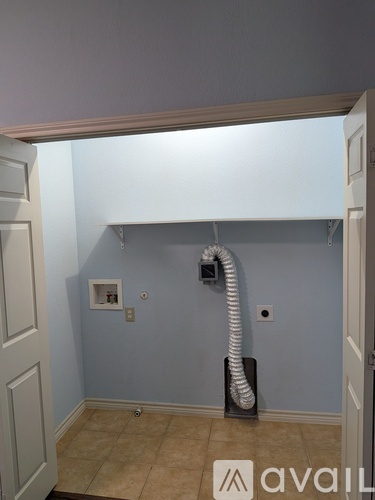 A room with a white door and a wall-mounted vacuum cleaner.