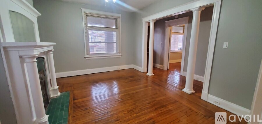 A room with wood floors and a fireplace is available.