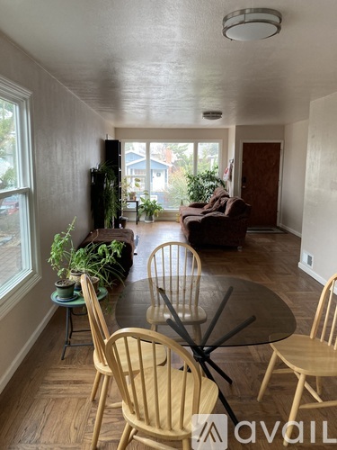 A living room with a table and chairs.