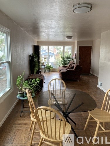 A living room with a table and chairs.