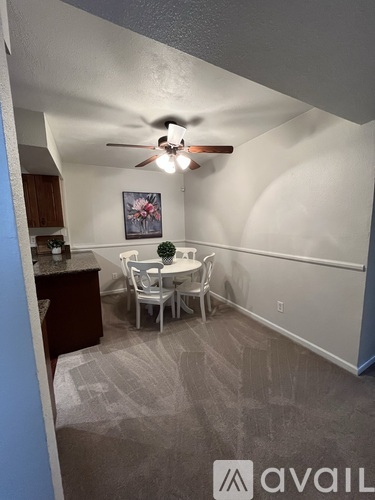 A dining room with a table and chairs.