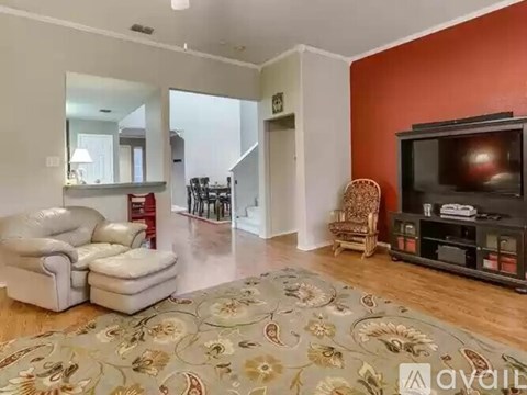 A living room with a grey sofa and a television.