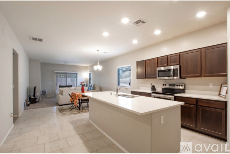 A spacious kitchen with brown cabinets and a white island.