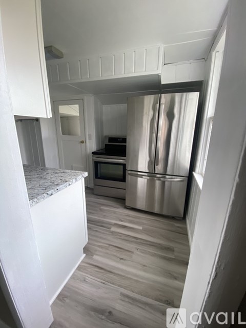A kitchen with a stainless steel refrigerator and oven.