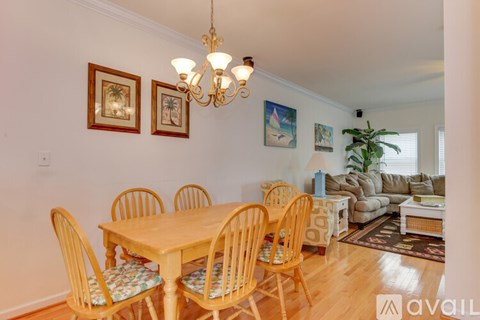 A dining room with a wooden table and chairs.