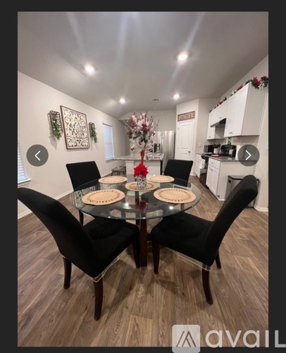 A dining room with a glass table and chairs.