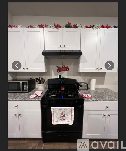 A black stove top oven with a towel on it in a kitchen.
