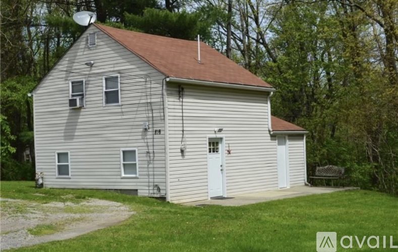 A house with a satellite dish on the roof.
